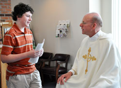 St. Paul the Apostle parishioner Ethan Gill of Greencastle, a longtime altar server and student at Greencastle Middle School, says goodbye to Father Stephen Jarrell during a June 27 farewell reception. Father Jarrell now serves as the pastor of Christ the King Parish in Indianapolis. &ldquo;He just brought us all together,&rdquo; Ethan said. &ldquo;I&rsquo;m going to miss him.&rdquo; (Photo by Mary Ann Wyand)