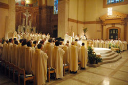 Scores of priests who minister in the Archdiocese of Indianapolis join Archbishop Daniel M. Buechlein in praying the eucharistic prayer during the annual chrism Mass on April 7, 2009, at SS. Peter and Paul Cathedral in Indianapolis. Father Patrick Beidelman, the archdiocesan director of liturgy, is leading a series of workshops to help priests in central and southern Indiana prepare to use the new English translation of the Roman Missal&mdash;the texts for the Mass&mdash;which will take effect during the weekend of Nov. 26-27, 2011. (File photo by Sean Gallagher)
