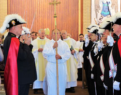 Members of the Knights of Columbus stand at attention during the closing procession of a Sept. 12 Mass at St. Michael Church in Charlestown to celebrate the parish&rsquo;s 150th anniversary. Archbishop Daniel M. Buechlein was the principal celebrant at the Mass. (Photo by Sean Gallagher)
