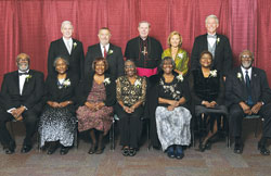 An archdiocesan celebration of Catholic education on Nov. 3 honored four individuals and one family whose Catholic values mark their lives. Standing, from left, are honoree James Schellinger, honoree Dr. Michael Welsh, Archbishop Daniel M. Buechlein, honoree Shirley Yancey Kloepfer and honoree William Kuntz. Sitting, from left, are honored members of the family of Archie and Bettie Smith&mdash;Joseph, Sister Demetria (a member of the Missionary Sisters of Our Lady of Africa), Bernadette, Carrie, Doris, Nellie and Holy Cross Brother Roy Smith. (Photo by Rob Banayote)
