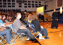 Father R. Tony Ricard, the Catholic chaplain for the New Orleans Saints, holds a carved stick from Senegal during his keynote address on the &ldquo;Pursuit of Glory&rdquo; on Nov. 7 at Bishop Chatard High School. (Photo by Mary Ann Wyand)