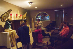 Kneeling in prayer before the Blessed Sacrament on Oct. 2 in the Good Shepherd Chapel at St. Mary (Nativity of the Virgin Mary) Parish in North Vernon are, from left, Zach Miller, Bailey Kilgore, Brock Leach and, partially obscured, Weston Miller. Seated, from left, are Mary Kilgore and Claudia Slabaugh. (Submitted photo/Missy Scarlett)