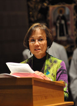 Dr. Pilar Sayoc, a member of St. Monica Parish in Indianapolis, presents a petition during the St.&nbsp;Martin de Porres feast day Mass on Nov. 3 at St. Thomas Aquinas Church. She also is a member of the archdiocesan Multicultural Ministry Commission. (Photo by Mary Ann Wyand)