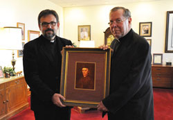 Father Guillaume Brut&eacute;, a seminary rector in Beirut, Lebanon, left, and Archbishop Daniel M. Buechlein pose for a photograph on Nov. 8 in the chancery at the Archbishop O&rsquo;Meara Catholic Center in Indianapolis. They are holding a portrait of the Servant of God Bishop Simon Guillaume Gabriel Brut&eacute; de R&eacute;mur, Father Brut&eacute;&rsquo;s great-great-great-great uncle. (Photo by Mary Ann Wyand)