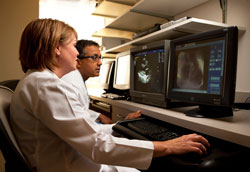 Sara Bodenmiller, left, and Dr. Simon Abraham examine the echocardiogram of a child to determine if the child is a good candidate for the life-saving heart surgery that is provided to poor pediatric patients from around the world by the Children&rsquo;s Heart Center at Peyton Manning Children&rsquo;s Hospital at St.&nbsp;Vincent Indianapolis Hospital. (Submitted photo)