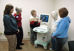 Eileen Hartman, center, shows an ultrasound machine on Jan. 7 at 1st Choice for Women to Jamie Wynberry, left, Anita Moody, Bobbie&nbsp;Lawless and Trish Funk, all nurses who are volunteering at&nbsp;the new crisis pregnancy center. It is an effort of the Gabriel&nbsp;Project, a parish-based, pro-life ministry active in many faith communities in central and southern Indiana. Hartman, a member of St. Bartholomew Parish in Columbus, is the executive director of the Gabriel Project. (Photo by Sean Gallagher)