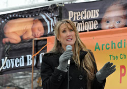 Respect Life Rally keynote speaker Rebecca Kiessling of Rochester&nbsp;Hills, Mich., an attorney and the mother of five children, shares her emotional pro-life story on Jan. 24 at Veterans&rsquo; Memorial Plaza in downtown Indianapolis. (Photo by Mary Ann Wyand)