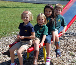 Phoebe Grote, left Bailey Lare, Aimee Corbin and Eric Frede, students at Pope John XXIII School in Madison, have fun on the school&rsquo;s playground in this file photo from September 2009. (Submitted photo)