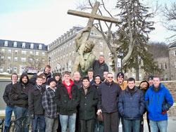 Seminarians enrolled at Bishop Simon Brut&eacute; College Seminary in Indianapolis pose on Jan. 21 in front of a statue of Bishop Brut&eacute;, the first bishop of Vincennes, on the campus of Mount St. Mary&rsquo;s University and Seminary in Emmitsburg, Md. Father Robert Robeson, the rector of Bishop Brut&eacute; Seminary, stands next to the statue. Father Patrick Beidelman, center in the second row, is the vice rector of Bishop Brut&eacute; Seminary. (Submitted photo)