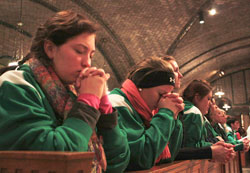 Zoe Kidwell, 17, left, and Angela Fowler, 18, students at Roncalli High School in Indianapolis, pray after receiving Communion during Mass before the annual March for Life on Jan.&nbsp;24. Pilgrims from the Archdiocese of Indianapolis filled the crypt church of the Basilica of the National&nbsp;Shrine of the Immaculate Conception in Washington, D.C., for the Mass. (Photo by Alea Bowling)