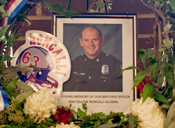 A memorial to Indianapolis Metropolitan Police Department officer David Moore is displayed in the front lobby of Roncalli High School in Indianapolis. A 2000 graduate of Roncalli High School, Moore died on Jan.&nbsp;26 after being shot during a traffic stop three days earlier. (Photo by Jay Wetzel)