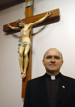 Father Vincent Lampert, the pastor of SS. Francis and Clare of Assisi Parish in Greenwood, poses on March 10 in his parish&rsquo;s church. Since 2005, Father Lampert has also been the exorcist of the Archdiocese of Indianapolis. In this ministry, he has ministered to people in central and southern&nbsp;Indiana and beyond. (Photo by Sean Gallagher)