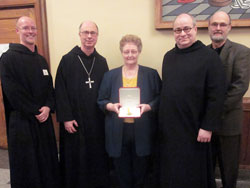 Marilyn Brahm of Ferdinand, Ind., center, was recently recognized by Pope Benedict XVI with the Pro Ecclesia et Pontifice (For the Church and the Pope) award. Pictured with her are, from left, Benedictine Father Adrian Burke, Saint Meinrad&rsquo;s business manager; Benedictine Archabbot Justin DuVall; Benedictine Father Denis Robinson, the president-rector of Saint Meinrad Seminary and School of Theology, and John Wilson, the general manager of Abbey Press. Brahm worked for 40 years as the executive secretary to four president-rectors at Saint Meinrad, including Archbishop Daniel M. Buechlein. (Photo courtesy of Saint Meinrad Archabbey)