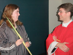 Father Sean Danda talks with University of Indianapolis senior Anne Marie Shipe after a Palm Sunday Mass on April 17 in the college&rsquo;s chapel. In his first year as the Catholic chaplain at the university, Father Danda has brought the sacraments and a caring, priestly presence to students, according to Shipe, a member of Christ the King Parish in South Bend, Ind., in the Fort Wayne-South Bend Diocese. (Photo by John Shaughnessy)