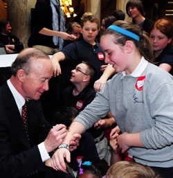 Gov. Mitch Daniels signs Celia Ward&rsquo;s arm following the school choice bill signing ceremony on May 5. Celia is a fourth-grade student at Central Catholic School in Indianapolis, one of four schools which make up the Mother Theodore Catholic Academies in Indianapolis. (Photo courtesy of Governor&rsquo;s Office)