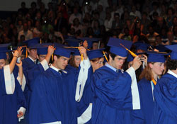 Bishop Chatard High School seniors take part in the &ldquo;turning of the tassel,&rdquo; which symbolizes a student&rsquo;s transition from candidate to graduate, during graduation ceremonies on May 23, 2010, at the Indianapolis North Deanery interparochial high school. Nearly 1,300 students will graduate from area Catholic schools in the next few weeks. (Submitted photo)