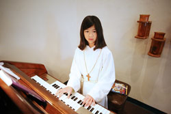 Courtney Berger, 11, plays the organ at St. Mark Church in Perry County. Courtney has accompanied the congregation&rsquo;s singing at the Tell City Deanery parish since she was 9, and also often assists as an altar server during Mass. (Photo by Danny Bolin)
