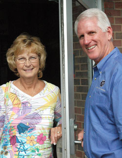 Kathy and Ed Tinder stand by the back door of Roncalli High School in Indianapolis where Ed first showed his romantic interest in Kathy 38 years ago when they both taught at the school. In their 37 years of marriage, the Tinders have dedicated their lives to young people through Ed&rsquo;s leadership of the Catholic Youth Organization and Kathy&rsquo;s career as a teacher. (Photo by John Shaughnessy)