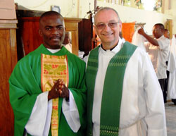 Father Thomas Clegg, right, pastor of St. Augustine and Most&nbsp;Sacred Heart of Jesus parishes, both in Jeffersonville, and Father Lesly DesHommes, a priest of the Archdiocese of Cap Hatien in Haiti, are pictured in February of 2011 after Father DesHommes&rsquo; ordination to the priesthood. Father DesHommes is one the first seminarians that the Jeffersonville parishes sponsored. This photograph was taken after his first Mass at St. Raphael Parish, the Jeffersonville parishes&rsquo; sister parish in Haiti. (Submitted photo)