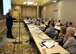 Father Patrick Beidelman, left, director of liturgy in the archdiocese&rsquo;s Office of Worship, speaks on Aug. 2 to directors of religious education, principals and youth ministers from across the archdiocese at the French Lick Resort in French Lick, Ind., about Masses with children. The workshop took place during the annual administrators&rsquo; conference sponsored by the archdiocese&rsquo;s Office of Catholic Education. (Photo by Sean Gallagher)