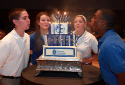Bishop Chatard High School students Nick Shultz, from left, Monica Ward, Lauren Taylor and Okenna Oruche blow out the candles on a cake celebrating the Indianapolis North Deanery archdiocesan high school&rsquo;s 50th anniversary on Sept. 13. (Submitted photo)