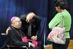 Jackie Byers, left, speaks to Archbishop Emeritus Daniel M. Buechlein after a press conference announcing his retirement on Sept. 21. Byers, a member of St. Simon the Apostle Parish in Indianapolis, is past president of the Archdiocesan Finance Council. Bishop Christopher J. Coyne, right, the archdiocese&rsquo;s new apostolic administrator, talks with Kevin Rader, a reporter for WTHR Channel 13 in Indianapolis. (Photo by Mary Ann Garber)
