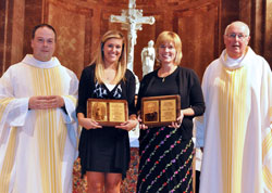 Victoria Nondorf, a member of St. Pius X Parish in Indianapolis, second from left, displays the 2011 Our Lady of Guadalupe Pro-Life Youth Award, and Dianna Meinecke, a member of St. Mary Parish in Navilleton, second from right, holds the 2011 Archbishop Edward T. O&rsquo;Meara Respect Life Award following the archdiocesan Respect Life Sunday Mass on Oct. 2 at SS. Peter and Paul Cathedral in Indianapolis. Posing with Victoria and Meinecke are Father Peter Marshall, left, associate pastor of St. Pius X Parish, and Msgr. Joseph Schaedel, pastor of St. Luke the Evangelist Parish in Indianapolis and principal celebrant of the annual pro-life liturgy. (Photo by Sean Gallagher)