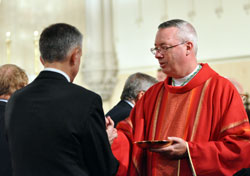 Bishop Christopher J. Coyne, apostolic administrator, gives Communion to&nbsp;a member of the St. Thomas More Society during the legal organization&rsquo;s annual Red Mass on Oct. 3 at St. John the Evangelist Church in Indianapolis. (Photo by Mary Ann Garber)