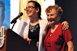 Pro-life activist Eva Muntean, left, of San Francisco hugs her mother, also named Eva Muntean, who is a member of St. Bartholomew Parish in Columbus, following her keynote speech at &ldquo;God Alone,&rdquo; the 2011 Indiana Catholic Women&rsquo;s Conference, on Sept. 17 at Cathedral High School in Indianapolis. (Photo by Mary Ann Garber)