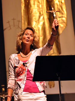 Catholic author Katrina Zeno of Phoenix holds a crucifix on Sept. 17 while explaining Church teachings on the resurrection of the body. She was one of three keynote speakers during &ldquo;God Alone,&rdquo; the 2011 Indiana Catholic Women&rsquo;s Conference, at Cathedral High School in Indianapolis. (Photo by Mary Ann Garber)