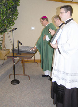 Bishop Timothy L. Doherty ceremonially &ldquo;throws the switch&rdquo; for the new Catholic radio station in Noblesville on Oct. 12. (Photo by Caroline B. Mooney/The Catholic Moment)