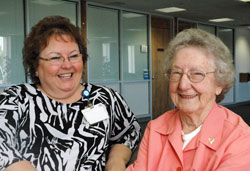 Nearing her 90th birthday, Kathryn Massing, right, continues to add to her 28 years and 35,000 hours of volunteer service at Franciscan St. Francis Health&ndash;Beech Grove. Here, she enjoys time with Sherri Walker, director of service excellence and volunteer services for the hospital. (Photo by John Shaughnessy)