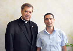 Franciscan Father Peter Vasko, left, president of the Franciscan Foundation for the Holy Land, poses on Sept. 21 at the Archbishop O&rsquo;Meara Catholic Center in Indianapolis with Zaki Sahlia, a Palestinian Catholic from Israel. Sahlia was visiting the United States to visit with and thank donors to the foundation who made possible college scholarships for himself and other young adult Palestinian Catholics. (Photo by Sean Gallagher)