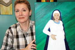 After the death of her mother, Kate Duffy Sim left her 32-year teaching career to focus her talents on painting images of the Blessed Mother. Here, she displays a painting of Mary pregnant with Jesus, a painting she titled &ldquo;The Ark of the New Covenant.&rdquo; (Photo by John Shaughnessy)