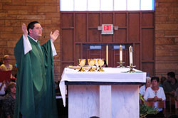Father Eric Augenstein, pastor of Our Lady of Perpetual Help Parish in New&nbsp;Albany, prays the eucharistic prayer during a Sept. 17 Mass at his parish&rsquo;s church. Our Lady of Perpetual Help and other parishes across central and southern Indiana have taken many approaches to preparing archdiocesan Catholics for the new Mass translation to be implemented on the weekend of Nov. 26-27. (Submitted photo)