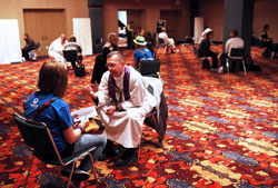 Priests listen to teenagers&rsquo; confessions in a room at the Indiana Convention Center on Nov. 18 during the National Catholic Youth Conference in Indianapolis. (Photo by Rich Clark)