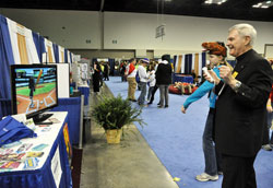 Archbishop Roger L. Schwietz of Anchorage, right, plays Wii baseball with Madelyn Kelty of Louisville, Ky., on Nov. 18 in the National Catholic Youth Conference&rsquo;s Vocations Village at the Indiana Convention Center in Indianapolis. (Photo by Sean Gallagher)