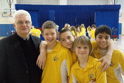 During his 10 years as the superintendent of Catholic schools in the archdiocese,&nbsp;Ron Costello has stressed a combination of academic excellence and values-based education. Here, Costello, who will retire on Dec. 31, poses for a photo with four students at Holy Name of Jesus School in Beech Grove. They include Dolan Monroe, left, Brad Meade, Zach Taylor and Gabriel Lopez. The photo was taken at the school after a Dec. 7 ceremony honoring Benedictine Sister Mary Nicolette Etienne, a religion teacher. (Photo by John Shaughnessy)