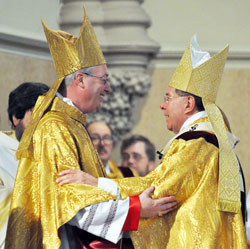 Archbishop Daniel M. Buechlein, right, exchanges a sign of peace with Bishop Christopher J. Coyne after ordaining him an auxiliary bishop on March 2 at St. John the Evangelist Church in Indianapolis. Bishop Coyne&rsquo;s appointment as auxiliary bishop and Archbishop Buechlein&rsquo;s early retirement in September were among the top local stories in 2011. (File photo by Mary Ann Garber)