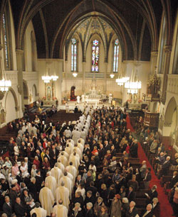 Priests, seminarians and members of Catholic fraternal organizations process into St. John the Evangelist Church at the start of the ordination Mass for Bishop Christopher J. Coyne on March 2, 2011. In the days leading up to Super Bowl XLVI on Feb. 5 at Lucas Oil Stadium in Indianapolis, St. John parishioners will serve as volunteer tour guides, known as &ldquo;St. John evangelists,&rdquo; to explain the history and religious significance of the architecture and other aspects of the parish&rsquo;s historic church. (File photo by John Shaughnessy)