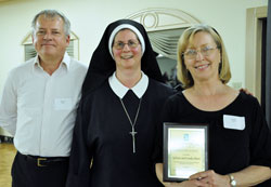 Our Lady of the Greenwood parishioners Sylvan Ebert, left, and Linda Ebert of Greenwood were among four recipients of 2012 Sanctity of Life Awards presented by Servants of the Gospel of Life Sister Diane Carollo, director of the archdiocesan Office for Pro-Life Ministry, during the office&rsquo;s third annual Sanctity of Life awards dinner and fundraiser on March 8 in Indianapolis. The Eberts are dedicated Birthline volunteers. (Photo by Mary Ann Garber)