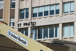 As the end of the week arrived for consolidating clinical services, workers were busy removing external signage at Franciscan St. Francis Health&rsquo;s hospital in Beech Grove. (Submitted photo)
