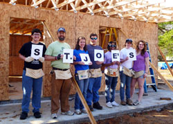 Conventual Franciscan Father John Bamman, second from left, associate pastor of St. Joseph University Parish in Terre Haute, and Rose-Hulman Institute of Technology students, from left, Kyle Bippus, Katherine Czaplicki, Michael Junge, Angelica Cox, Katelyn Stenger and Lisa Lillis help build a house in Tupelo, Miss., during the St. Joseph University Parish campus ministry service trip from Feb. 26 to March 3 as part of Habitat for Humanity&rsquo;s Collegiate Challenge, a national project to help the poor. (Submitted photo)