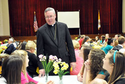 Bishop Christopher J. Coyne, apostolic administrator, talks with peer mentors during the A Promise to Keep: God&rsquo;s Gift of Human Sexuality luncheon on April 23 at the Archbishop O&rsquo;Meara Catholic Center in Indianapolis. The abstinence education program is administered by Margaret Hendricks and Sylvia Brunette, staff members of the archdiocesan Office of Catholic Education. (Photos by Mary Ann Garber)