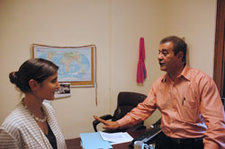 As World Refugee Day nears on June 20, Gabrielle Neal, director of the archdiocese&rsquo;s Refugee Resettlement Program, talks with Sajjad Mohammed Jawad, the 2011 Refugee of the Year who now works for Catholic Charities Indianapolis helping refugees adjust to life in central Indiana. (Photo by John Shaughnessy)