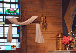 The tabernacle and large, rough-hewn bark cross at St. Ann Church in Terre Haute are among the liturgical furnishings and other items donated by the parish to the archdiocesan seminary, local churches and St. Luke Parish in Salyersville, Ky., whose church was destroyed by a tornado on March&nbsp;2. St. Ann Parish was closed by the archdiocese on May 20 as part of the Terre Haute Deanery future parish staffing plan. (Photo by Mary Ann Garber)