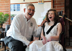Deacon Thomas Ward poses for pictures with Leia Stone, a St. Simon the Apostle parishioner and SPRED participant, after the archdiocesan Special Religious Development Mass on June 10 at St. Lawrence Church in Indianapolis. Deacon&nbsp;Daniel Collier also assisted with the liturgy. (Photo by Mary Ann Garber)