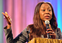 Immacul&eacute;e Ilibagiza clutches a rosary as she shares her story of surviving the genocide in Rwanda in 1994 during a July 20 keynote speech at the National Black Catholic Congress in Indianapolis. Some of the proceeds from the sale of her books benefit children in Africa. (Photo by Mary Ann Garber)