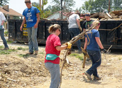High school students on the archdiocese&rsquo;s Homeland Mission project on June 24-29 help clear debris left by the tornadoes that devastated the southern Indiana community of Henryville on March 2. (Submitted photo)