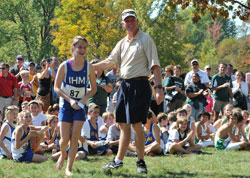 Smiles, sunshine and snapshots mark the festivities following the Catholic Youth Organization&rsquo;s All-City Cross Country meet in 2011. CYO executive director Ed Tinder congratulates Katherine Free, a runner from Immaculate Heart of Mary Parish in Indianapolis, during the post-race celebration. (Submitted photo/Kent Hughes)
